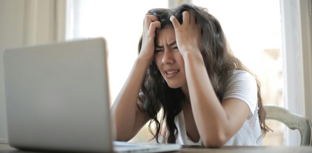 Stressed or anxious woman at laptop (Photo by Andrea Piacquadio used with permission)